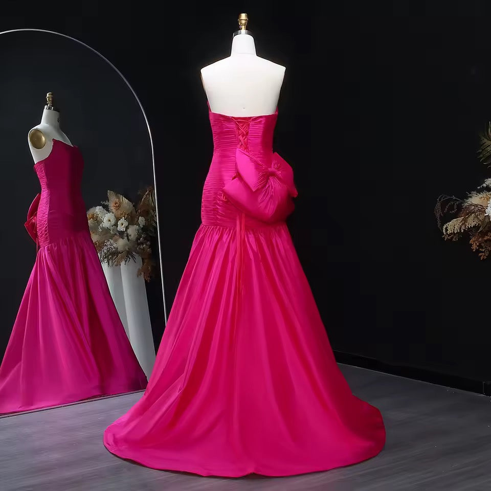 Shiny mermaid dress with elegant pleated details and bold back bow