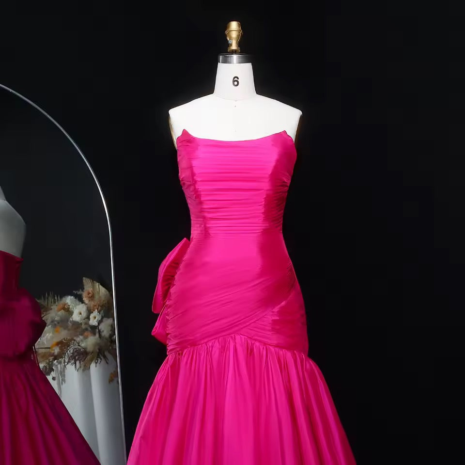 Shiny mermaid dress with elegant pleated details and bold back bow