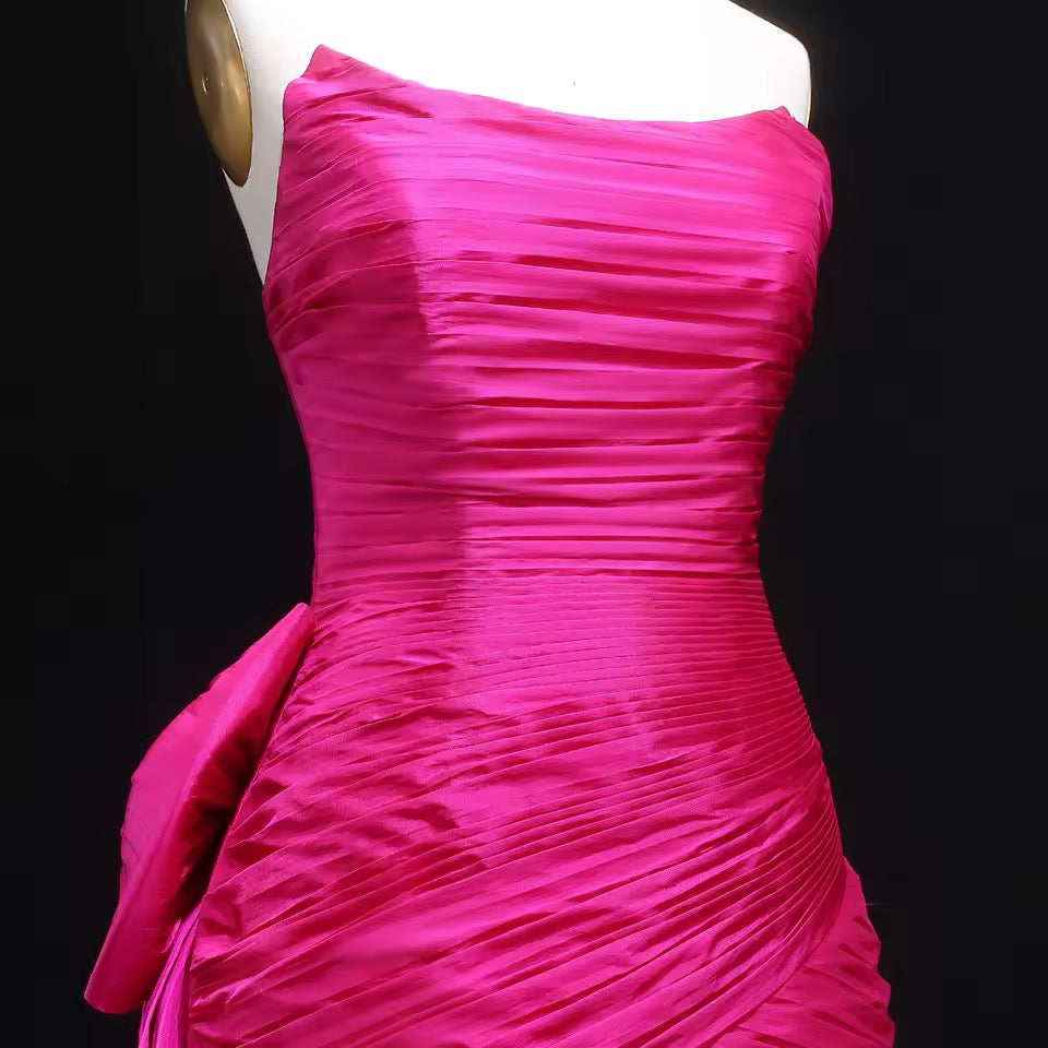Shiny mermaid dress with elegant pleated details and bold back bow