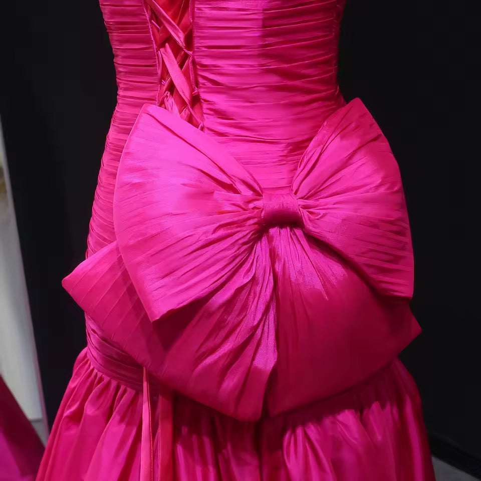 Shiny mermaid dress with elegant pleated details and bold back bow