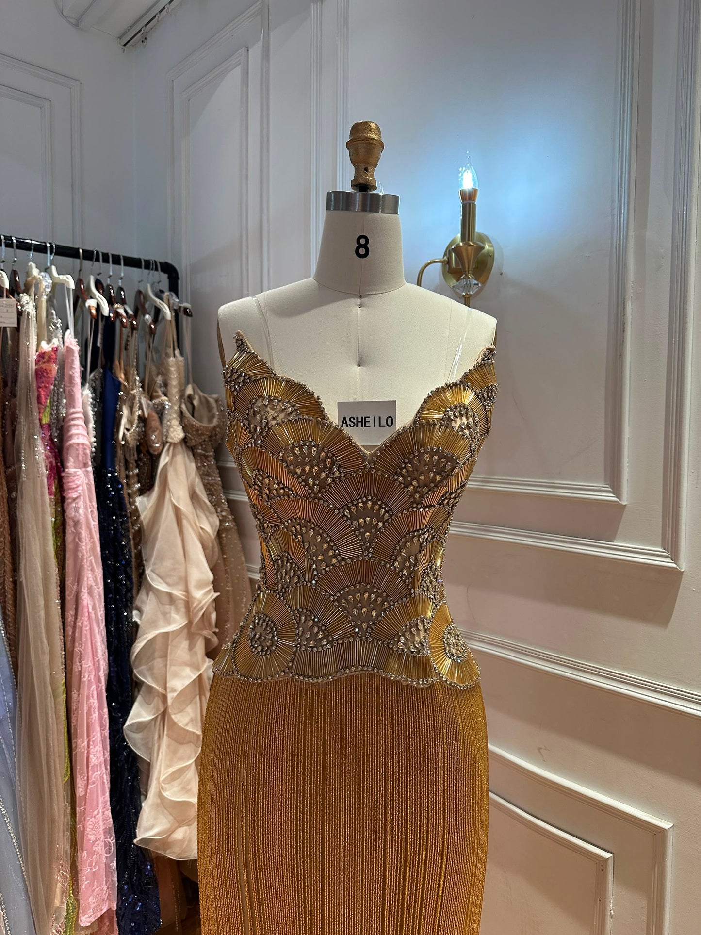 Glamorous Gold Strapless Gown with Shell-Inspired Crystals and Radiant Tassel Skirt