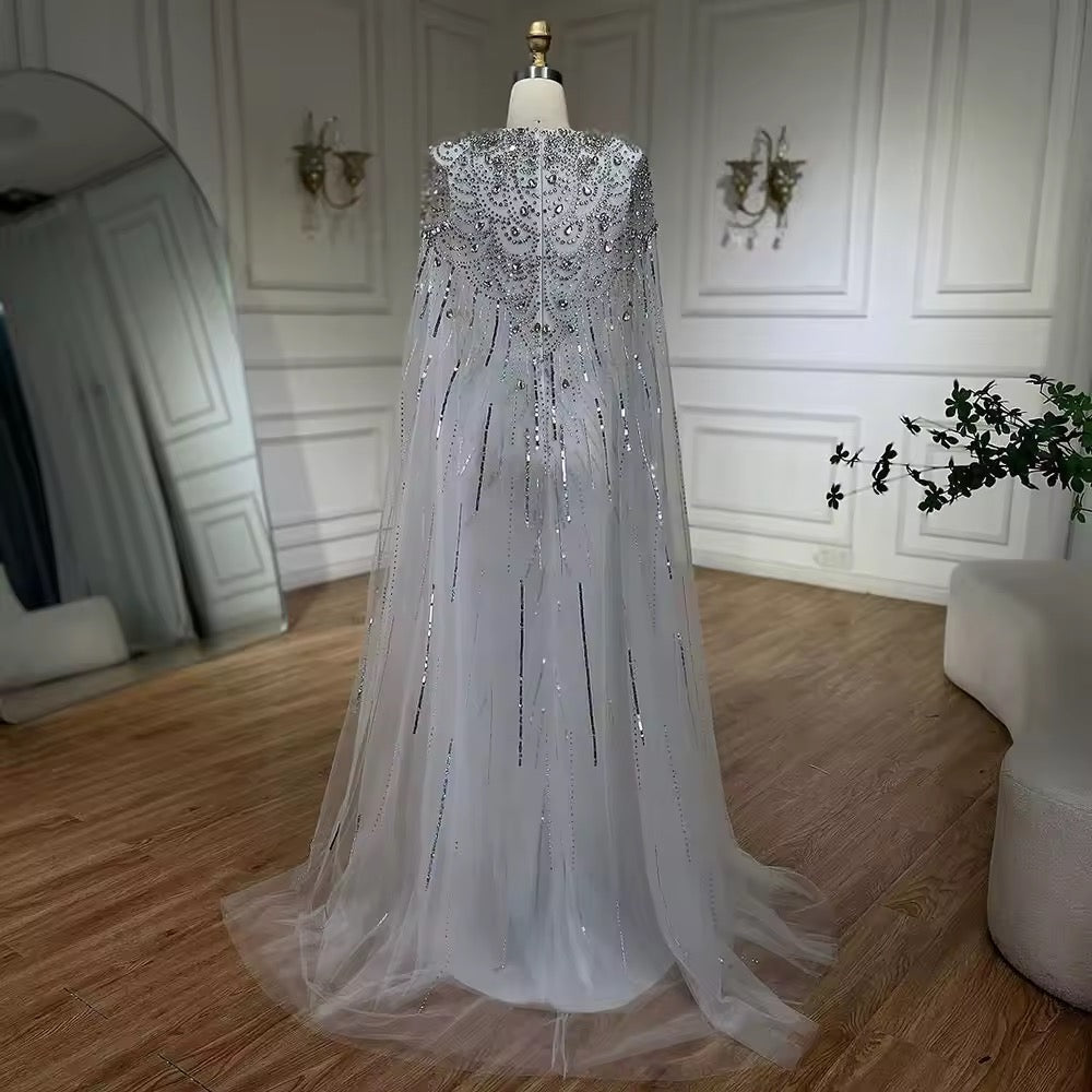 Elegant Fitted Gown with Beaded Details and Dramatic Cape