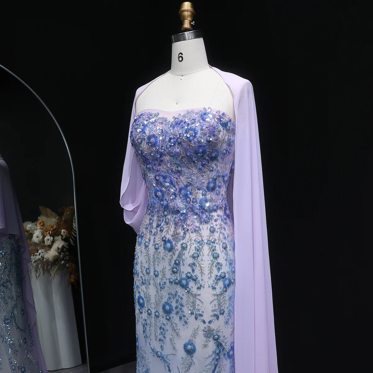 Whispering Bloom Embroidered Gown with Draped Cape and 3D Blue Florals