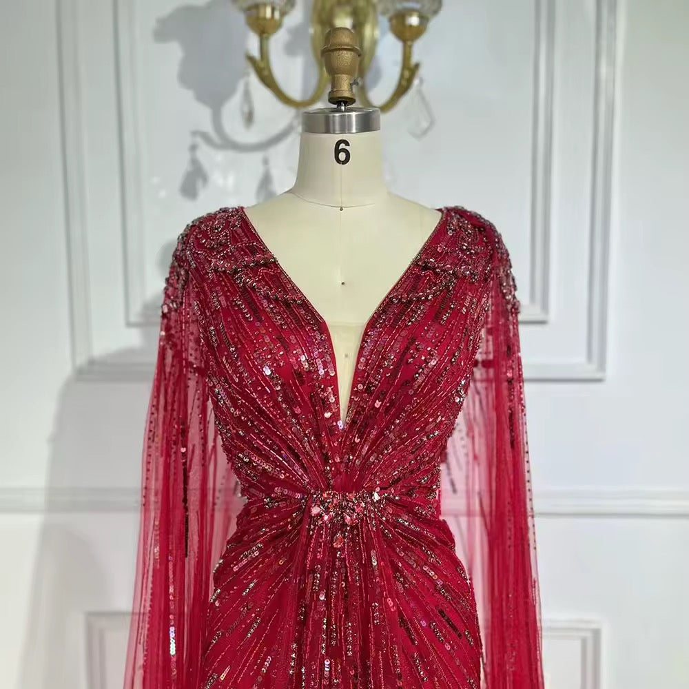 Elegant Fitted Gown with Beaded Details and Dramatic Cape