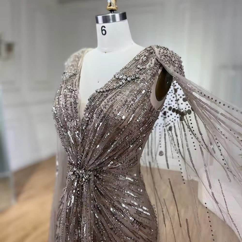 Elegant Fitted Gown with Beaded Details and Dramatic Cape