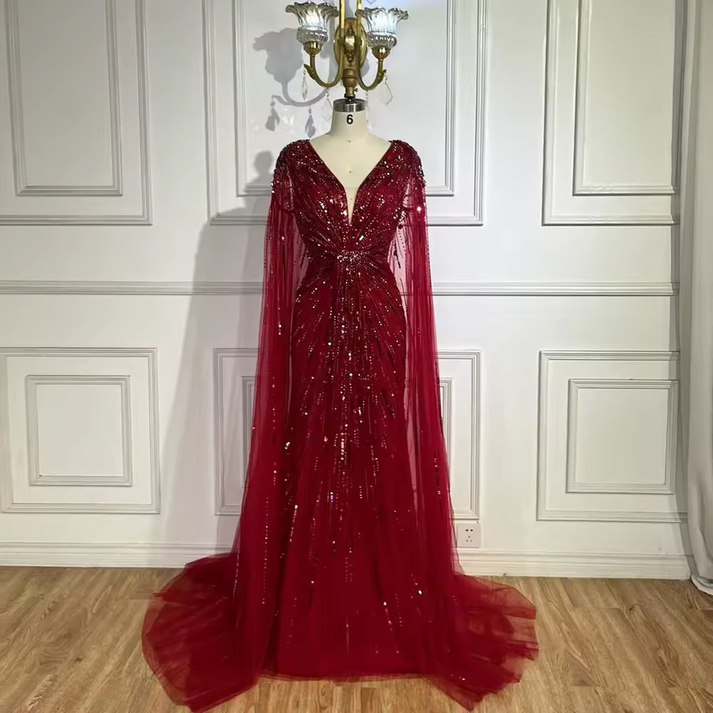 Elegant Fitted Gown with Beaded Details and Dramatic Cape
