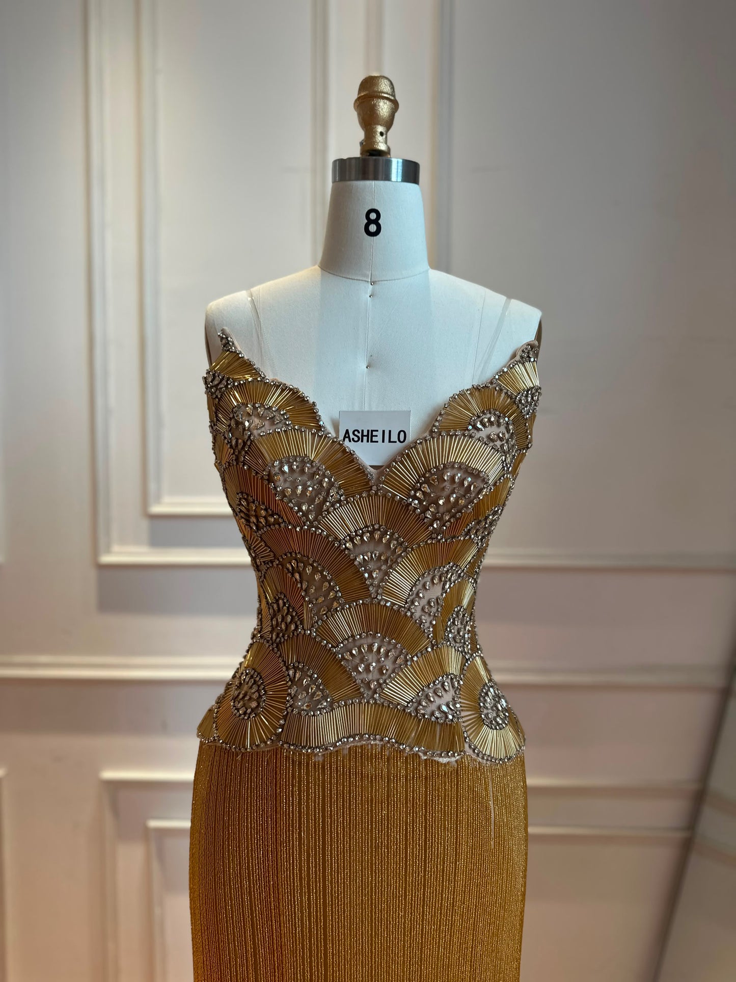 Glamorous Gold Strapless Gown with Shell-Inspired Crystals and Radiant Tassel Skirt