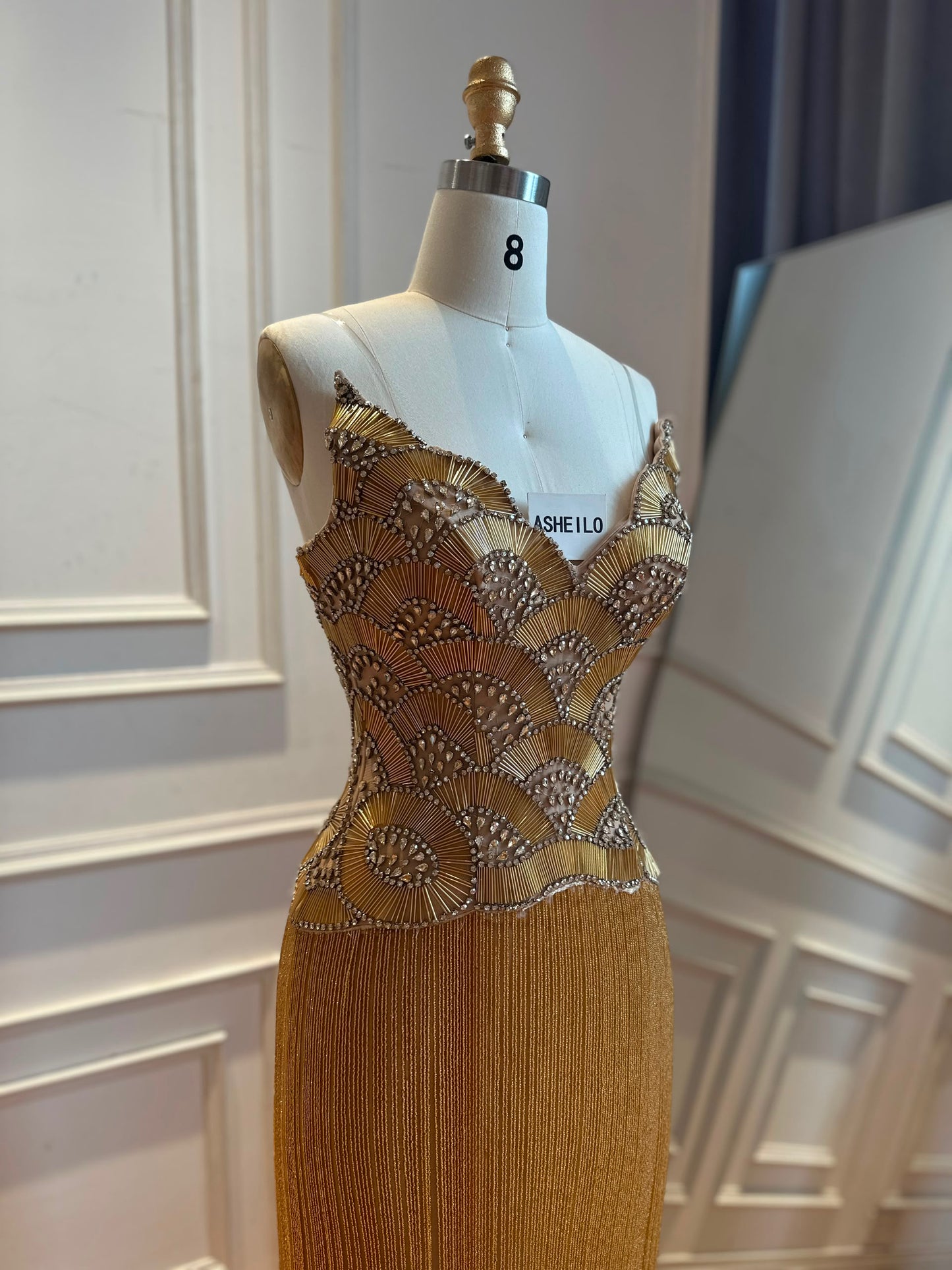Glamorous Gold Strapless Gown with Shell-Inspired Crystals and Radiant Tassel Skirt